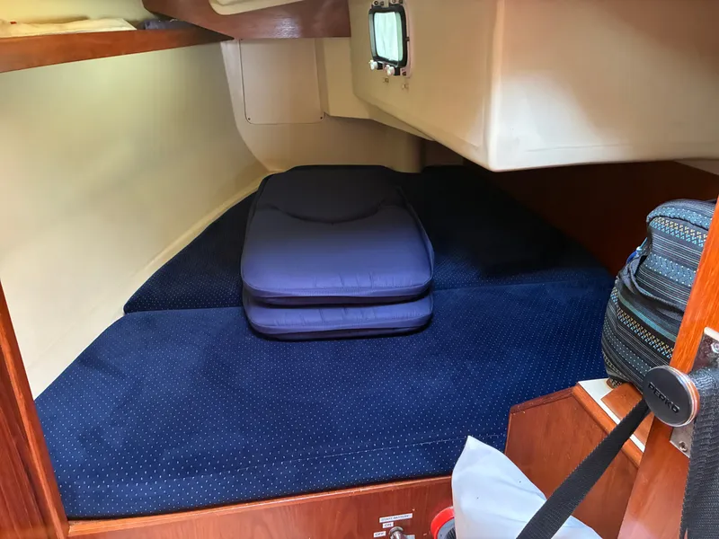 Slide: The Image of The cabin of a 1988 Pearson 33-2 with blue cushions and a small window. - 39