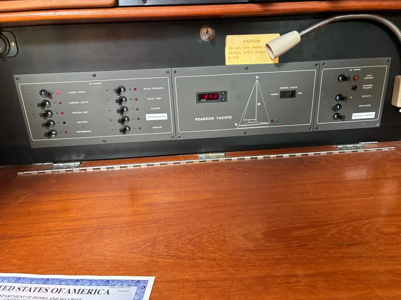 Slide: The Image of The image shows the control panel of a 1988 Pearson 33-2 yacht with various switches and displays. - 45