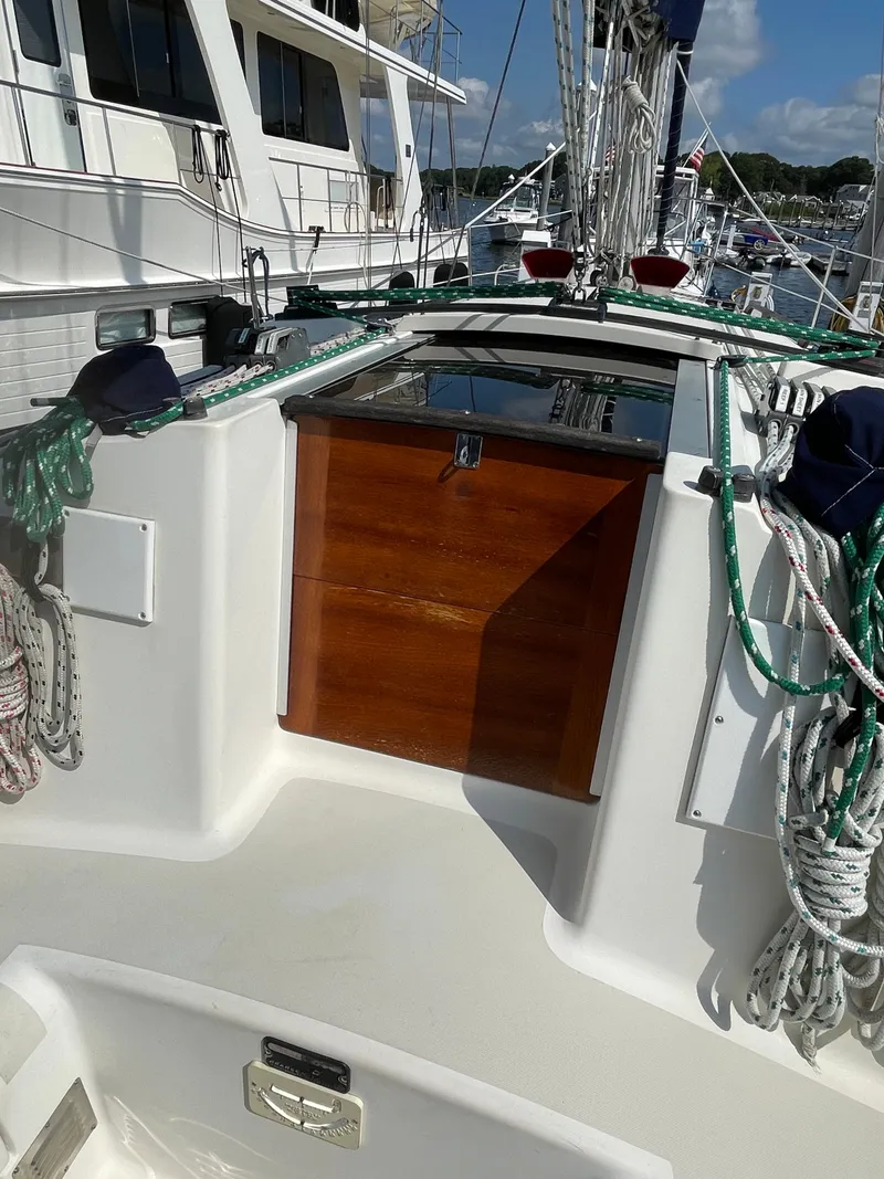 Slide: The Image of The image shows the cockpit of a 1988 Pearson 33-2 with a wooden door and ropes. - 17