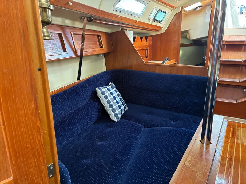 Slide: The Image of Interior of a 1988 Pearson 33-2 with blue upholstery and wood finish. - 29