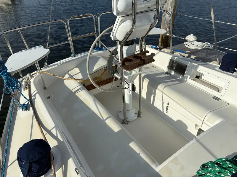 Slide: The Image of The image shows the cockpit of a 1988 Pearson 33-2 with a steering wheel and seating. - 12