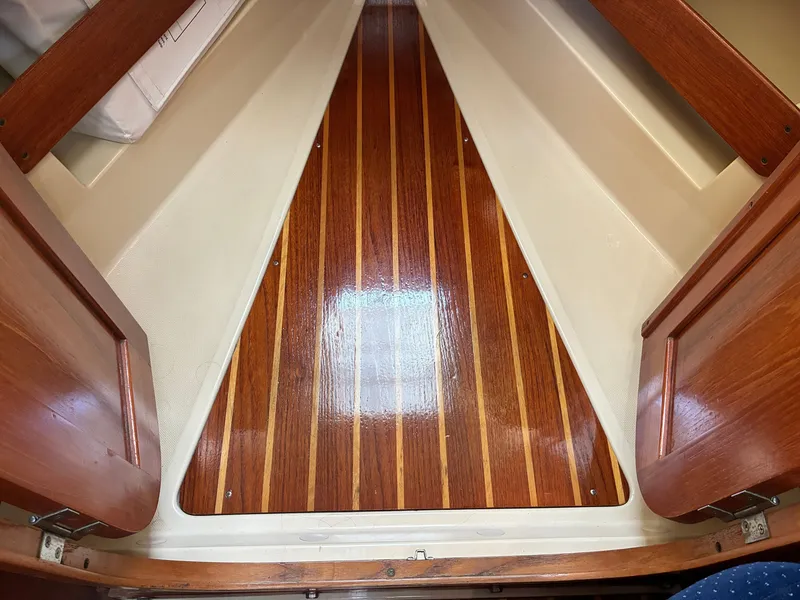 Slide: The Image of The interior of a 1988 Pearson 33-2 features a glossy, striped wooden floor. - 35
