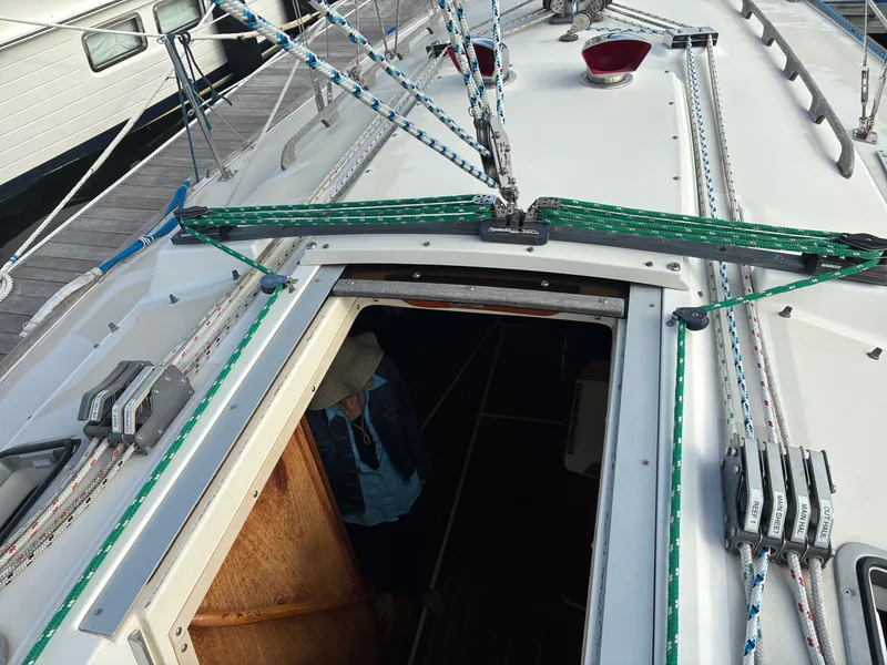 Slide: The Image of The deck of a 1988 Pearson 33-2 with ropes and an open hatch. - 18