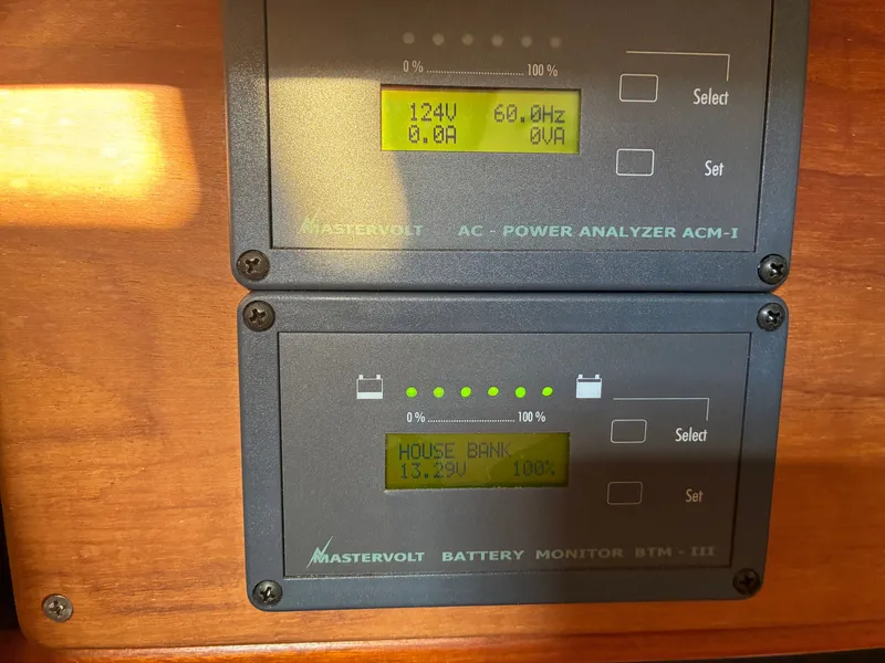 Slide: The Image of Two Mastervolt displays on a wooden panel show electrical readings, including voltage and battery status. - 42