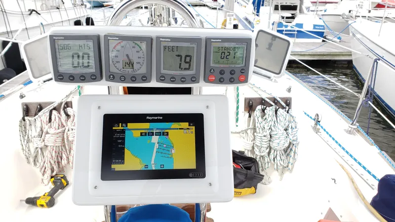 Slide: The Image of The cockpit of a 1988 Pearson 33-2 features navigation instruments and a modern display. - 16