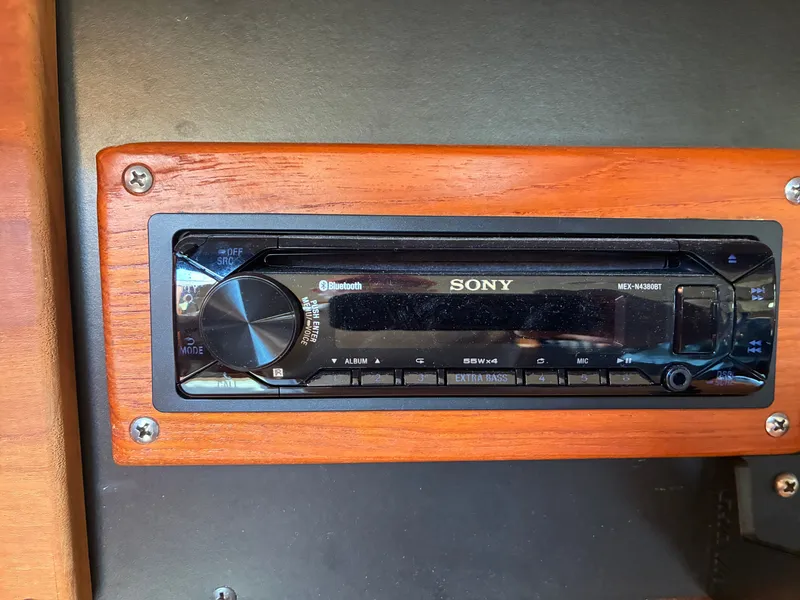 Slide: The Image of A Sony car stereo is mounted in a wooden frame, surrounded by black panels. - 43