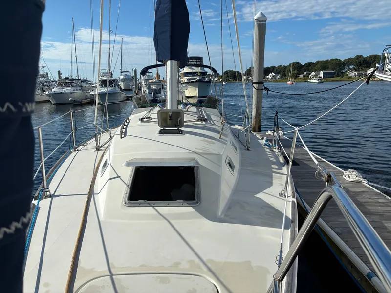 Slide: The Image of A 1988 Pearson 33-2 sailboat docked, with other boats visible in the background. - 6