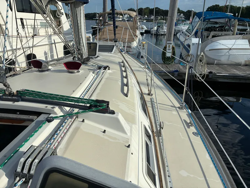 Slide: The Image of The deck of a 1988 Pearson 33-2 in a marina, surrounded by other boats. - 9