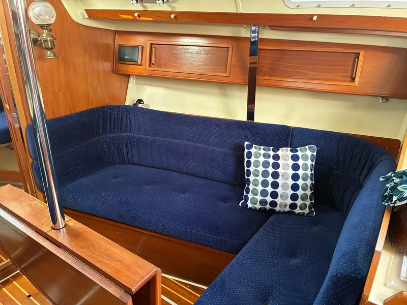 Slide: The Image of The image shows a cozy cabin with a blue upholstered seating area and a patterned cushion. - 31