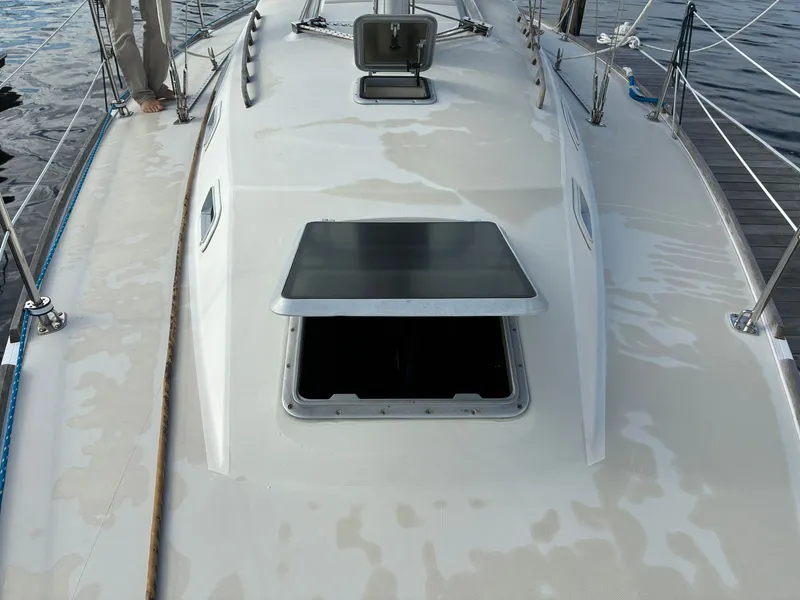 Slide: The Image of The deck of a 1988 Pearson 33-2 with an open hatch and ropes along the sides. - 7