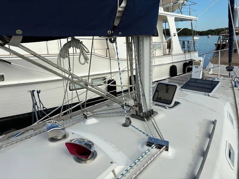 Slide: The Image of The deck of a 1988 Pearson 33-2 with sailing equipment and a tablet on the cockpit. - 10