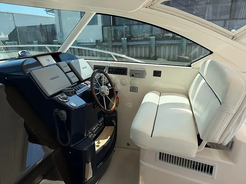 Slide: The Image of The cockpit of the 2013 Tiara Yachts 3600 Open features white upholstery and modern instruments. - 12