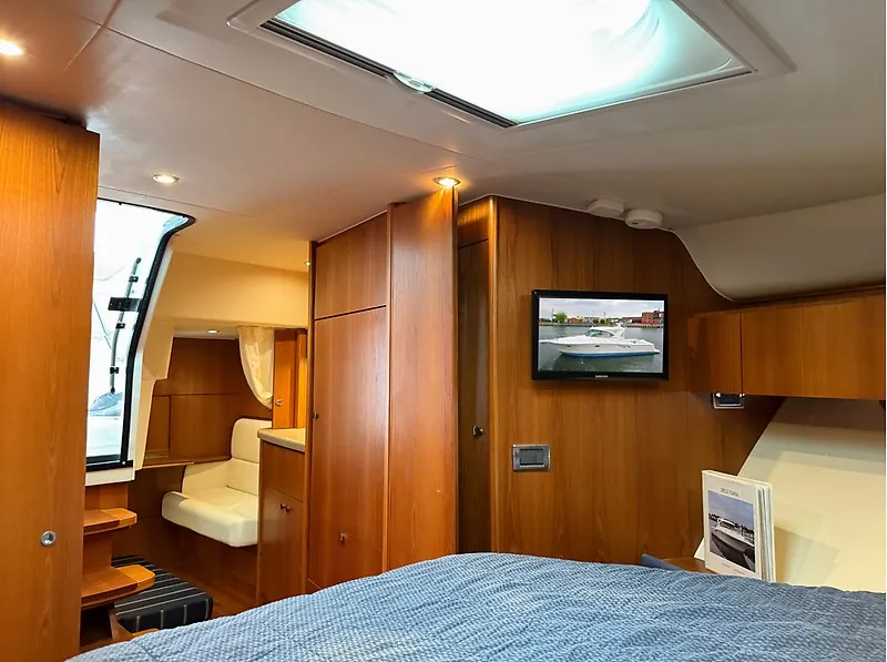 Slide: The Image of The cabin of a 2013 Tiara Yachts 3600 Open with wood furnishings and a flat-screen TV. - 26