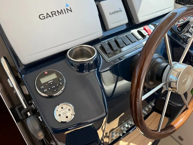Slide: The Image of The image shows the helm of a 2013 Tiara Yachts 3600 Open with Garmin equipment. - 16