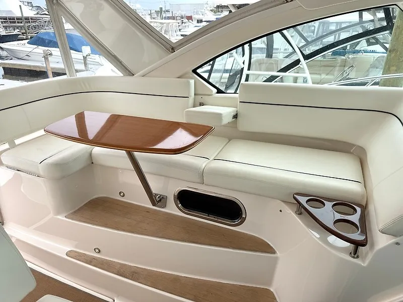 Slide: The Image of The 2013 Tiara Yachts 3600 Open features an elegant seating area with a wooden table and cup holders. - 10
