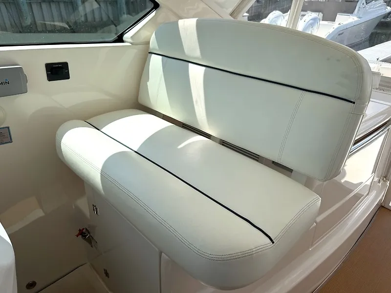 Slide: The Image of The 2013 Tiara Yachts 3600 Open features a white, cushioned bench seat in the interior. - 13