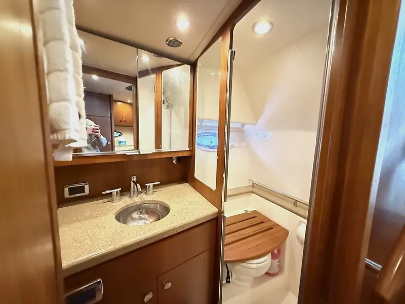 Slide: The Image of The image shows a yacht's elegant bathroom with a sink, mirror, and toilet. - 33