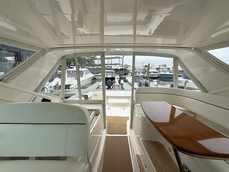 Slide: The Image of Interior view of a 2013 Tiara Yachts 3600 Open with seating area and wooden table. - 8
