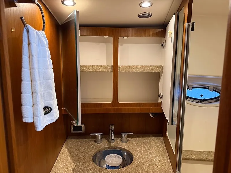 Slide: The Image of The image shows the bathroom of a 2013 Tiara Yachts 3600 Open with a sink and mirrors. - 32