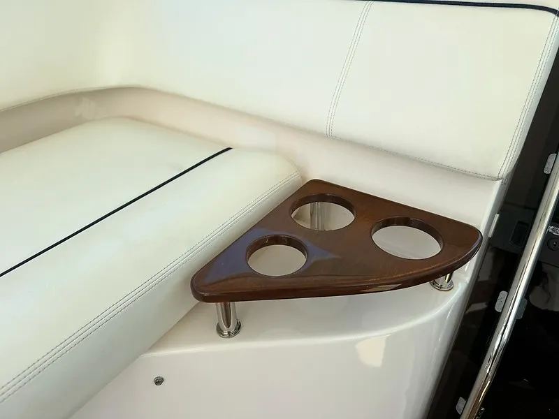 Slide: The Image of The 2013 Tiara Yachts 3600 Open features elegant white upholstery and a wooden cup holder. - 11