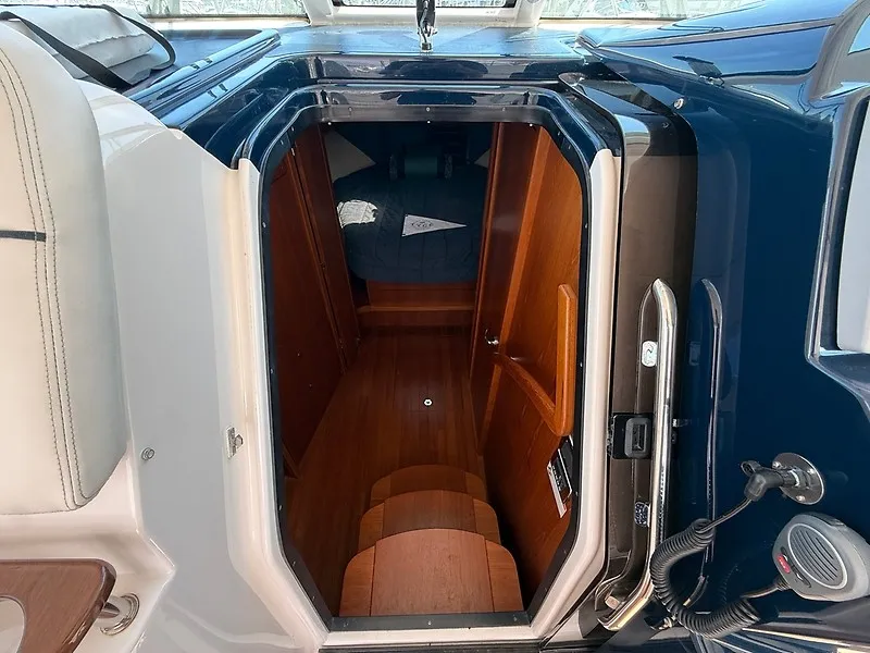 Slide: The Image of View into the cabin of a 2013 Tiara Yachts 3600 Open with wood flooring and blue upholstery. - 23