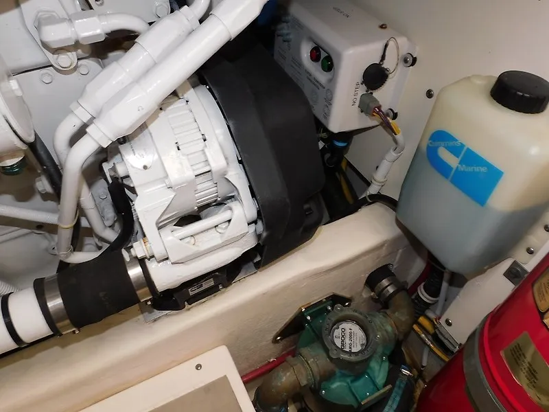 Slide: The Image of The engine compartment of a 2013 Tiara Yachts 3600 Open, featuring technical components and hoses. - 46