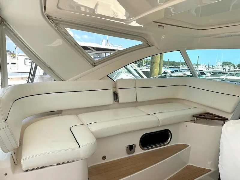 Slide: The Image of The image shows the cockpit of a 2013 Tiara Yachts 3600 Open with white upholstery. - 9