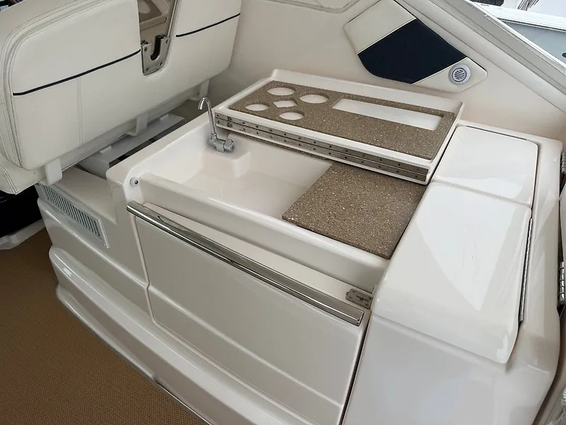 Slide: The Image of The 2013 Tiara Yachts 3600 Open features a sleek white kitchenette with a sink and counter space. - 19