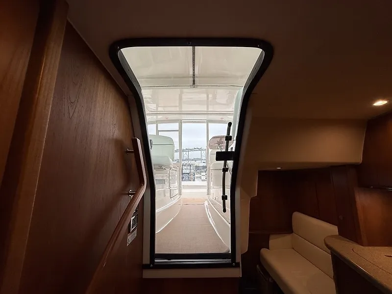 Slide: The Image of The cabin of a 2013 Tiara Yachts 3600 Open, showing the cockpit and harbor view. - 24