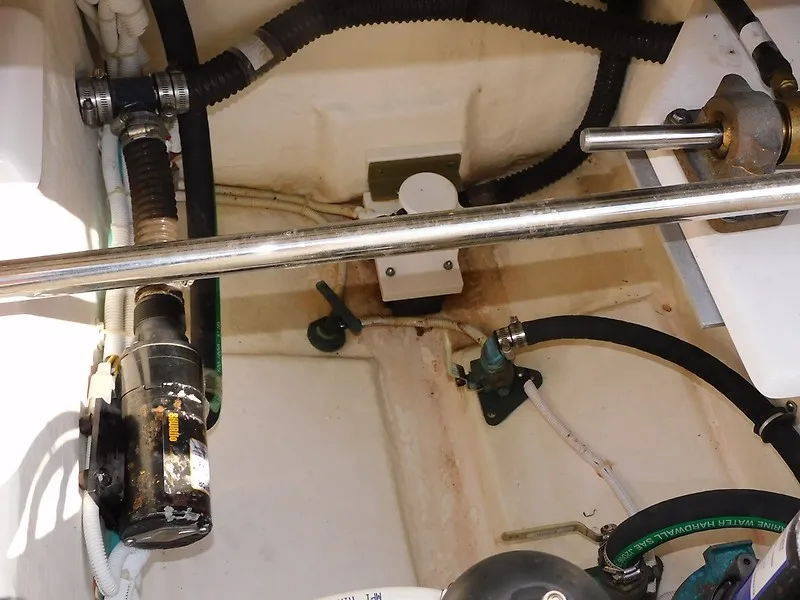 Slide: The Image of A view inside the engine compartment of a 2013 Tiara Yachts 3600 Open, showing various hoses and pipes. - 47
