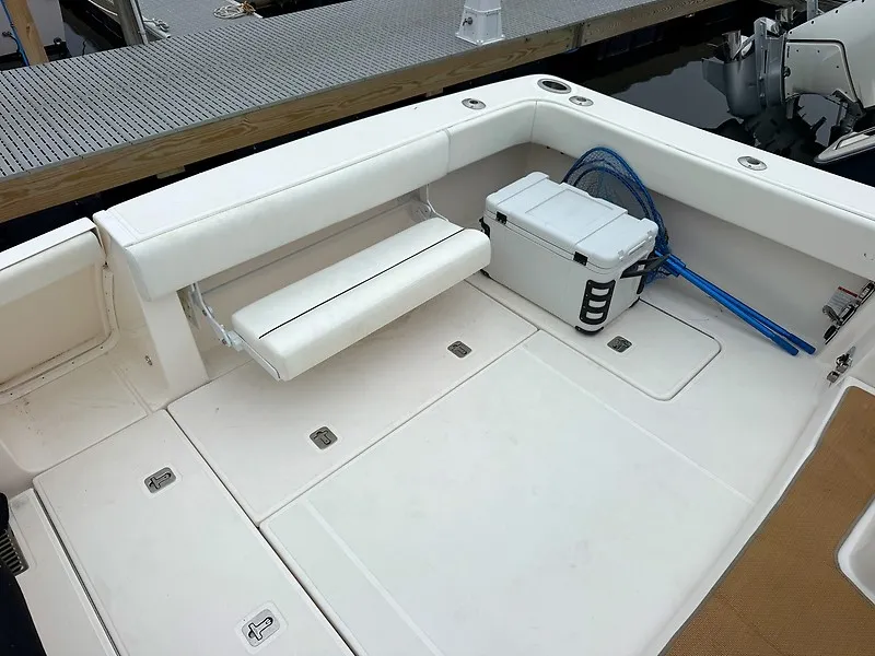 Slide: The Image of The image shows the cockpit of a 2013 Tiara Yachts 3600 Open with white seating and a cooler. - 5