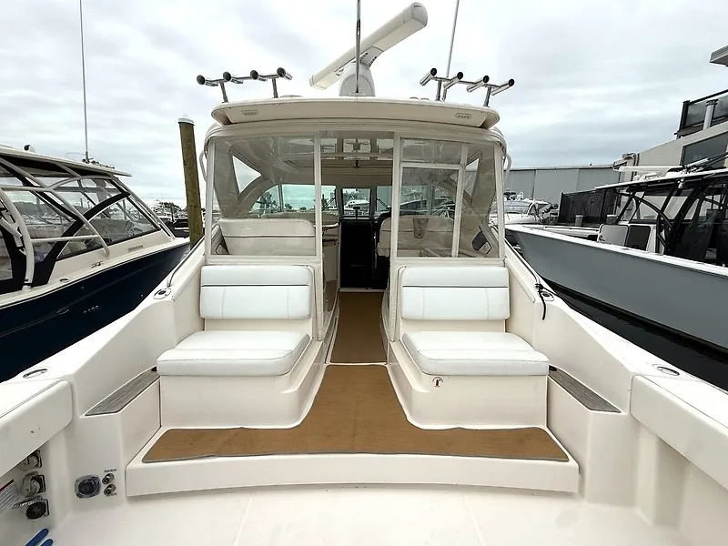Slide: The Image of The 2013 Tiara Yachts 3600 Open features a spacious cockpit with white seating and clear covers. - 3
