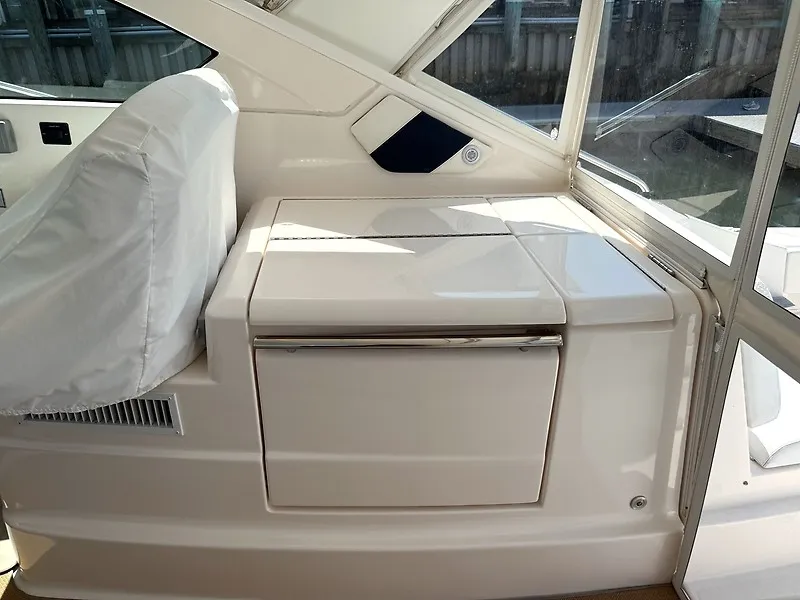 Slide: The Image of Interior view of a 2013 Tiara Yachts 3600 Open, featuring a white, cushioned seating area. - 21