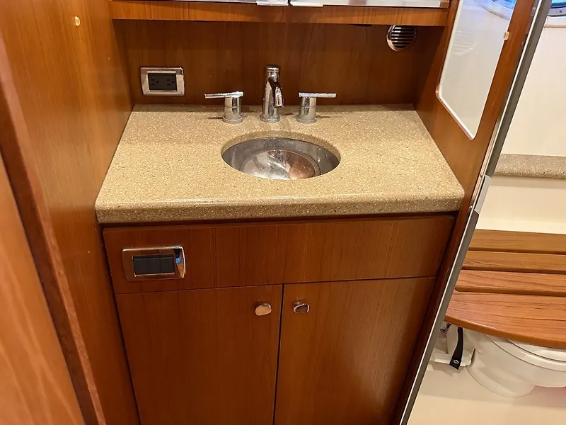 Slide: The Image of A sleek bathroom with a stainless steel sink and wooden cabinetry on a 2013 Tiara Yachts 3600 Open. - 34