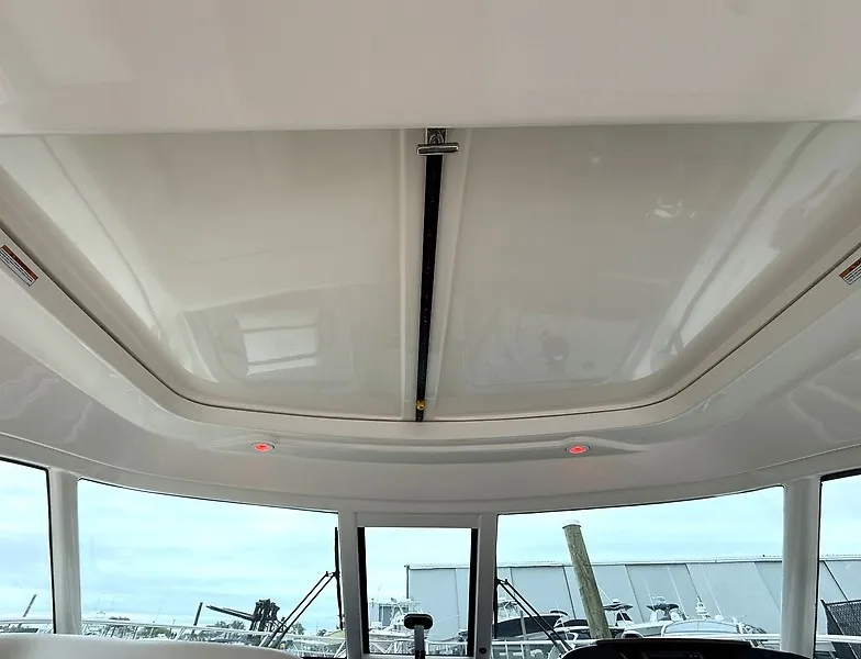 Slide: The Image of Interior view of a 2013 Tiara Yachts 3600 Open with a bright ceiling and windows. - 22