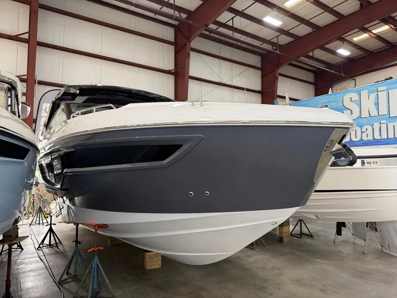 The Image of The 2027 Cruisers Yachts 38 GLS is in a warehouse. It features a sleek, modern design. - 0