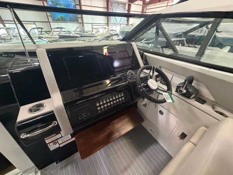 Slide: The Image of The cockpit of the 2027 Cruisers Yachts 38 GLS features a modern helm with a large display. - 33