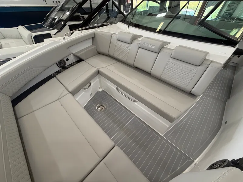 Slide: The Image of The 2027 Cruisers Yachts 38 GLS features a luxurious, cushioned seating area with gray accents. - 30