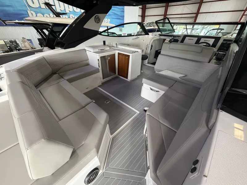 Slide: The Image of Interior of a Cruisers Yachts 38 GLS with gray seating and a small kitchenette. - 37