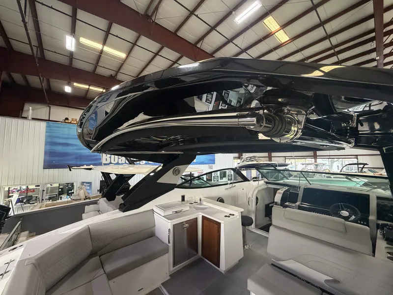 Slide: The Image of Interior view of a modern yacht with sleek seating and a small kitchenette. - 13