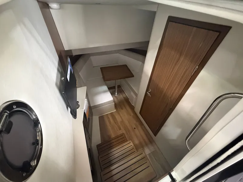 Slide: The Image of Interior of the Cruisers Yachts 38 GLS with wood flooring, table, and TV. - 18