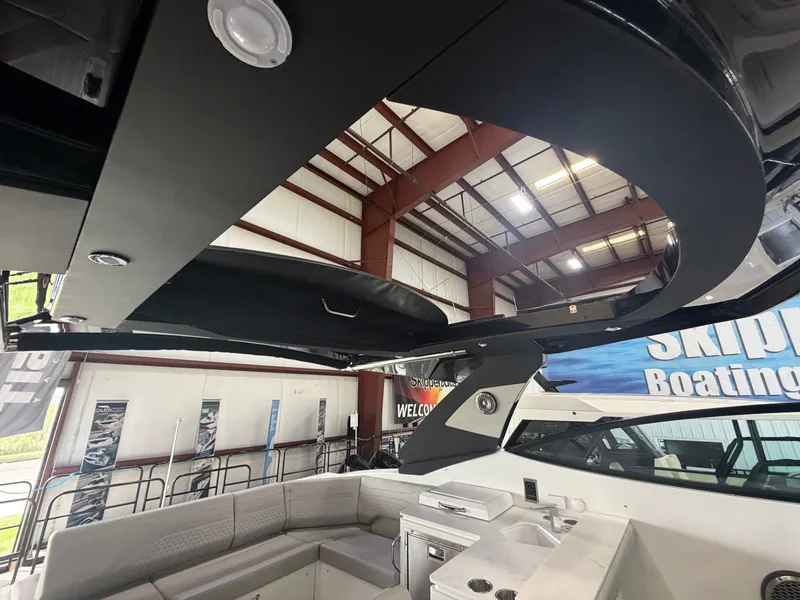Slide: The Image of Interior view of a modern yacht with sleek seating and a small kitchenette. - 32