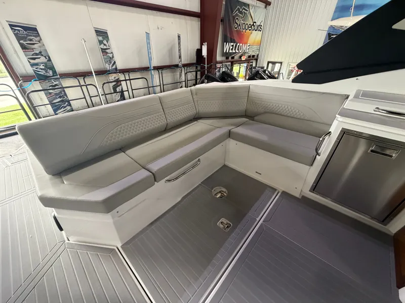 Slide: The Image of The 2027 Cruisers Yachts 38 GLS features a sleek, gray seating area in the interior. - 10