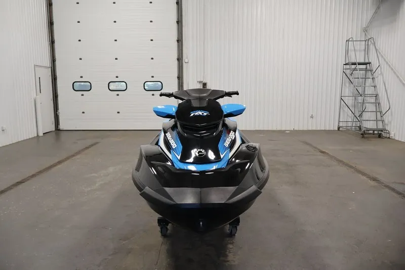 Slide: The Image of 2017 Sea-Doo RXT 260 jet ski in a spacious indoor garage. - 4