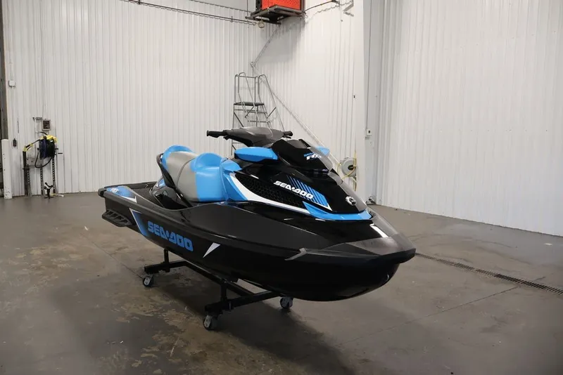 Slide: The Image of 2017 Sea-Doo RXT 260 jet ski in a garage, featuring sleek black and blue design. - 2