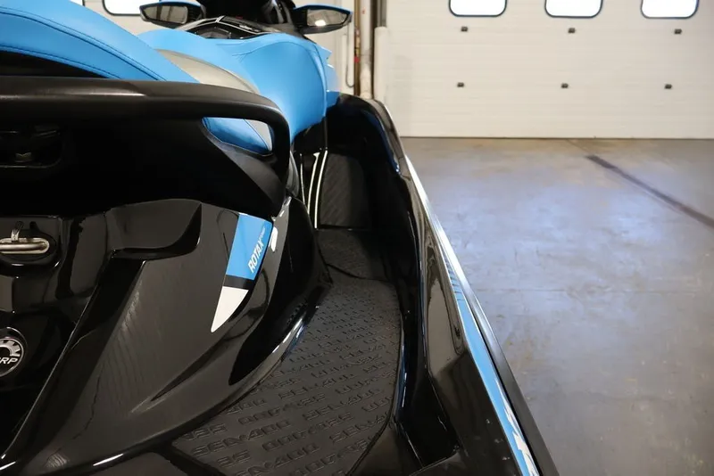 Slide: The Image of 2017 Sea-Doo RXT 260 jet ski in a garage, showcasing sleek design and vibrant blue color. - 21