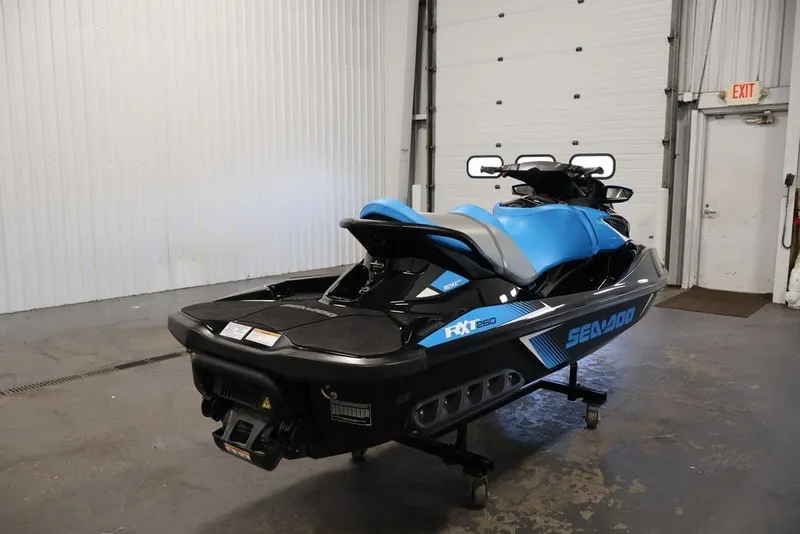 Slide: The Image of 2017 Sea-Doo RXT 260 jet ski in a garage, showcasing sleek design and vibrant colors. - 3