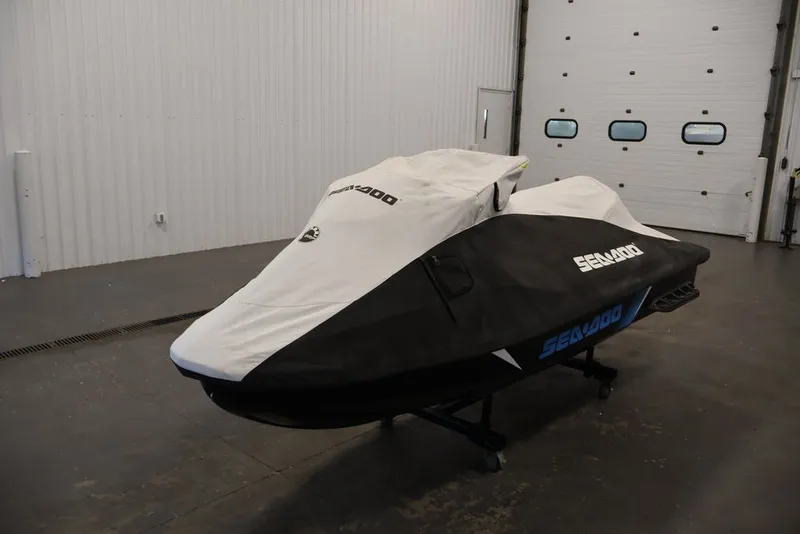 Slide: The Image of 2017 Sea-Doo RXT 260 jet ski covered in a garage setting. - 18