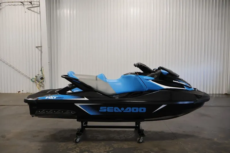 Slide: The Image of 2017 Sea-Doo RXT 260 jet ski in blue and black, displayed indoors. - 9