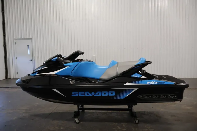 Slide: The Image of 2017 Sea-Doo RXT 260 jet ski in a showroom, featuring a sleek blue and black design. - 12